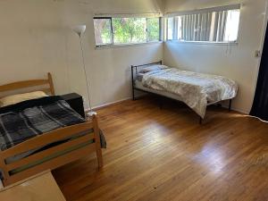 a bedroom with two beds and a wooden floor at 4 Room Sleeps 8plus Tranquil Home in Santa Cruz +12 photos