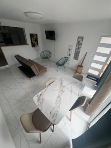 a room with a table and chairs and an umbrella at Charming house in a natural setting in Sainte-Rose