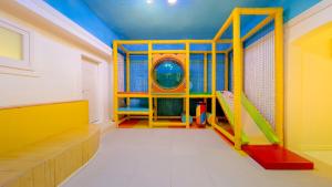 a gymnasium with a yellow and orangerior at Gapyeong Pogny Kids Poolvilla in Gapyeong +3 photos