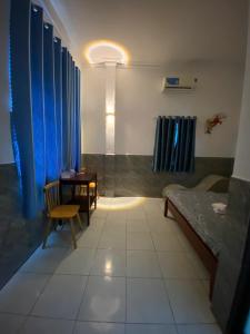 a room with a bed and a desk and a table at Nhà Nghỉ 36 in Ga Trảng Bôm +4 photos