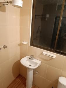 a bathroom with a sink and a window and a toilet at Artistic Mini Loft & Sun Terrace in La Paz