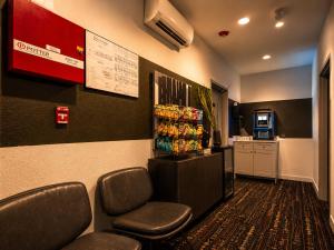 a waiting room with chairs and a drink machine at Roami at Zuni in Denver