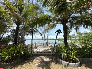 a path leading to a beach with palm trees at Twin Double Room in Phú Ngọc (1)