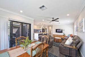 a living room with a couch and a table at Serenity Place in Mannering Park