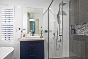 a bathroom with a sink and a shower at Serenity Place in Mannering Park +16 photos