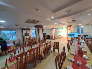 a dining room with long tables and chairs at Chu Long Hotel & Spa in Cat Ba