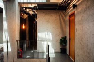 a hallway of a building with a red fire extinguisher at Luk Hostel in Bangkok +37 photos
