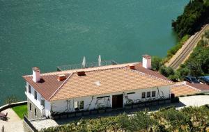 an aerial view of a house next to the water at Quinta Da Marka in Covas do Douro