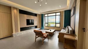 a living room with a couch and a tv at Fan's Hotel Palo in Tacloban