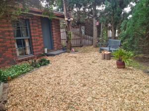 a yard with a bench and a house at Private Studio Ensuite & Kitchenette in Glen Waverley +10 photos