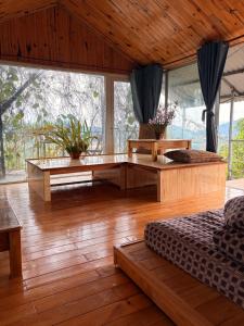 a living room with a couch and a table at Vườn của mẹ in Da Lat