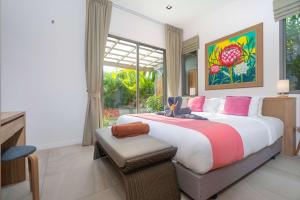 a bedroom with a large bed and a window at Tropical Private Pool Villa Dalaa 9 in Kamala Beach +20 photos