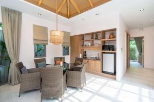 an open kitchen and dining room with a table and chairs at Tropical Private Pool Villa Dalaa 9 in Kamala Beach