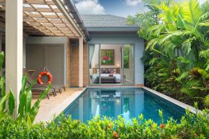 a swimming pool in a villa with a patio at Tropical Private Pool Villa Dalaa 9 in Kamala Beach