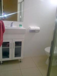 a white bathroom with a sink and a toilet at Renmark Motor Inn in Renmark +16 photos
