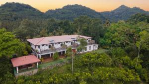 an aerial view of a house in the mountains at Jim's Farm Villas in Madawala
