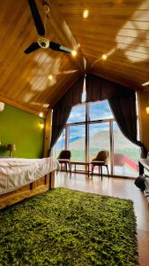 a bedroom with a bed with a green wall at Oasis Resort in Skardu