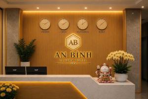 a lobby with clocks on the wall and a counter at An Bình Luxury Hotel in Bắc Giang