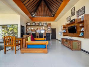a living room filled with furniture and a tv at Terrace Bali Villa in Nusa Dua