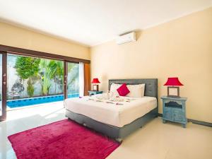 a bedroom with a bed and a large window at Terrace Bali Villa in Nusa Dua +43 photos