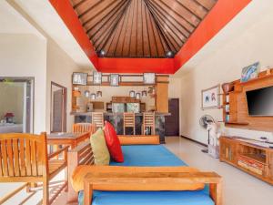 a living room with a couch and a table at Terrace Bali Villa in Nusa Dua