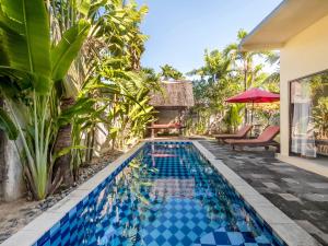a swimming pool in the backyard of a villa at Terrace Bali Villa in Nusa Dua