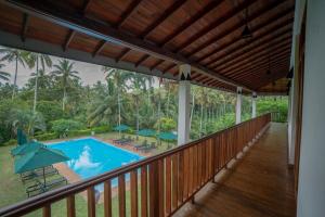 a view from the balcony of a resort with a swimming pool at Jim's Farm Villas in Madawala