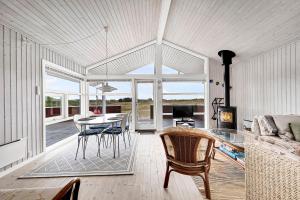 a living room with a dining table and chairs at Holiday House On Fanø Near The Sea in Fanø