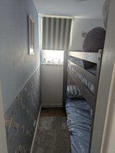 a small room with a bunk bed in it at The Lighthouse Chalet in Leysdown-on-Sea