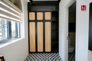 a bathroom with a black door with a tile floor at HL Villa in Dong Hoi