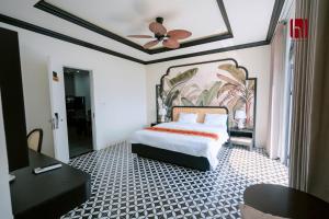 a bedroom with a bed and a ceiling fan at HL Villa in Dong Hoi +49 photos