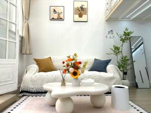 a living room with a white couch and a table at Duplex Garden Villa with Private Courtyard Jing'an Villa Near Metro Downtown Shanghai in Shanghai