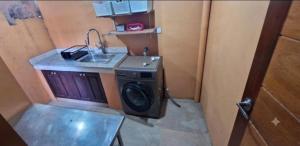 a laundry room with a washing machine and a sink at Nicholas Residence in Silang +6 photos