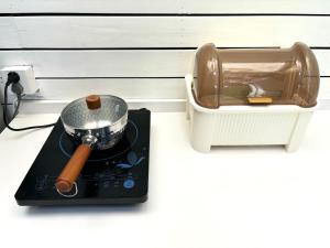 a pot and a pan on top of a stove at Duplex Garden Villa with Private Courtyard Jing'an Villa Near Metro Downtown Shanghai in Shanghai