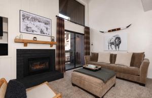 a living room with a couch and a fireplace at Epic Condo walk to Canyon Lodge in Mammoth Lakes