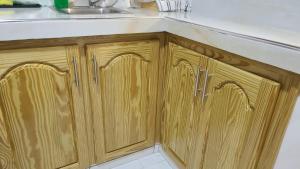 a kitchen counter with a sink and wooden cabinets at Lorenton Hideaway Studio in Lucea +6 photos