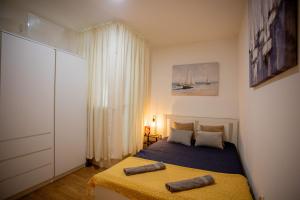 a bedroom with a bed with two towels on it at Casa Nora in centre of Vodnjan - Happy Rentals in Vodnjan