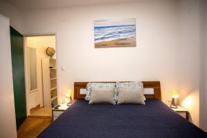 a bedroom with a blue bed with two pillows at Casa Nora in centre of Vodnjan - Happy Rentals in Vodnjan