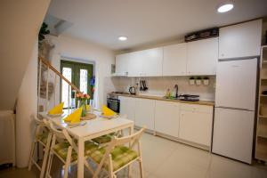 a kitchen with white cabinets and a table and chairs at Casa Nora in centre of Vodnjan - Happy Rentals in Vodnjan +26 photos