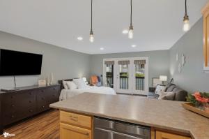 a kitchen and living room with a bed and a tv at Alyeska Mountain Side Retreat! in Girdwood