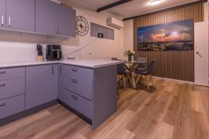 a kitchen with blue cabinets and a table in a room at The Stapleton in Kalgoorlie