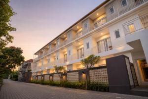 a large white building with lights on a street at Double A Cozy Living in Canggu