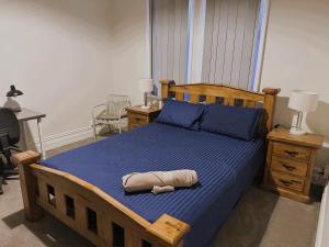 a bedroom with a bed with a stuffed animal on it at The Stapleton in Kalgoorlie