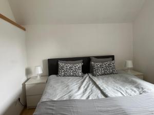 a bedroom with a bed with two night stands and two lamps at Auszeit im Hunsrück in Braunshorn +1 photo