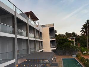 a hotel with a swimming pool and a building at Mazarin Hiriketiya in Dickwella +14 photos