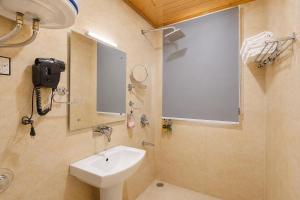 a bathroom with a sink and a mirror at Palette Hotel Regency Valley View Pahalgam By CheckIn in Batakūt +90 photos