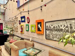 a room with a couch and a table and a picture on a wall at La Casa Azul Hostal in Morelia
