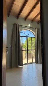 an open door to a room with a large window at Pousada Akros in Asunción