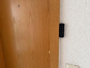 a door with a remote control on a wall at Modernes Apartment mit Balkon in Wutöschingen