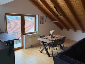 a dining room with a table and chairs and a window at Modernes Apartment mit Balkon in Wutöschingen